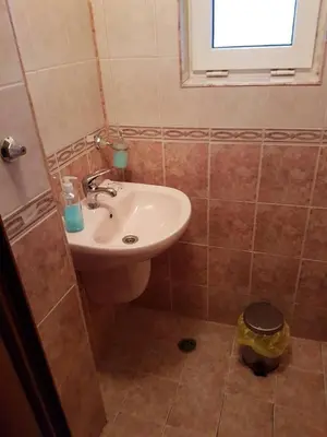 a bathroom with a sink and a window at Guest House Iveta in Sofia