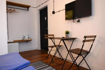 a room with a table and two chairs and a tv at Generaator Sofia in Sofia