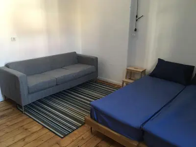 a living room with a couch and a bed at Generaator Sofia in Sofia