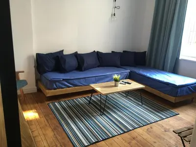 a blue couch in a living room with a coffee table at Generaator Sofia in Sofia