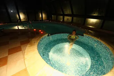 a woman in a swimming pool in a building at Evridika Hotel in Devin