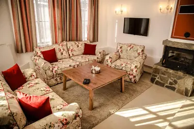 a living room with two couches and a coffee table at Red House in Koprivshtitsa