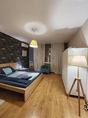 a bedroom with a bed and a lamp in it at Sunny Central Apartment in Sofia