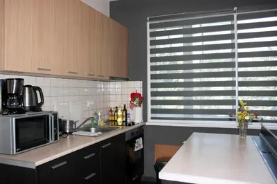 a kitchen with a sink and a microwave at Sunny Central Apartment in Sofia