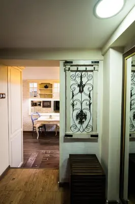 a room with a wall with a wrought iron gate at Vintage Lozenets Apartment in Sofia