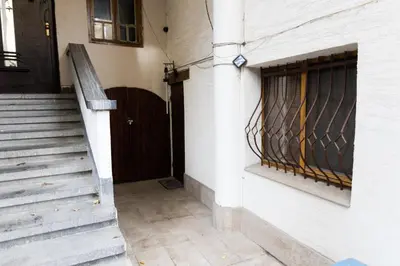a staircase leading to a door with a iron gate at Vintage Lozenets Apartment in Sofia