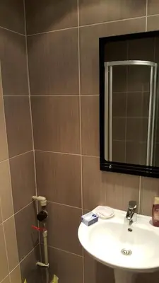 a bathroom with a sink and a mirror at City Sandanski in Sandanski
