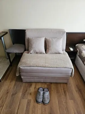 a bed with a pair of shoes in a room at City Sandanski in Sandanski