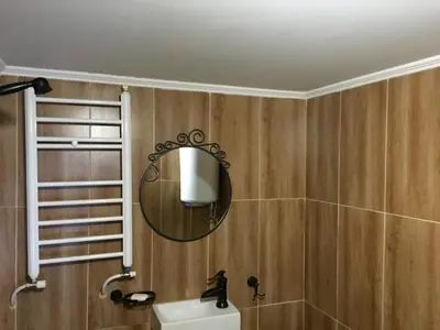 a bathroom with a mirror and a sink at ЧОЛАКОВАТА КЪЩА in Koprivshtitsa
