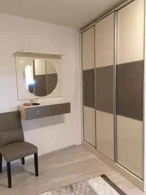 a room with a chair and a mirror at Apartments Park Place in Sandanski