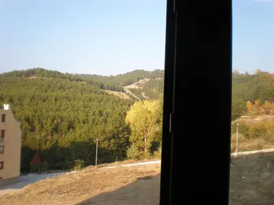 a view of a mountain from a window at Вихрен-стаи и апартаменти за гости in Sandanski