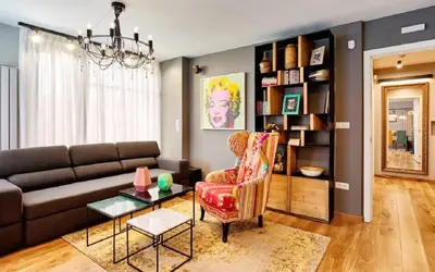 a living room with a couch and a chair at Stylish and High-end Designer Apartments in City Center in Sofia
