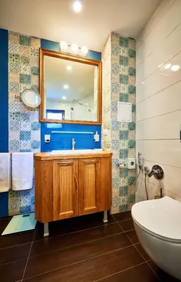 a bathroom with a sink and a mirror at Stylish and High-end Designer Apartments in City Center in Sofia