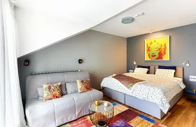 a bedroom with a bed and a couch at Stylish and High-end Designer Apartments in City Center in Sofia