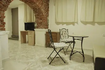 a room with a table and two chairs and a table at Interhost Guest rooms and apartments in Sofia