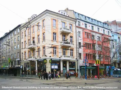 a building on a street with people walking in front of it at Interhost Guest rooms and apartments in Sofia