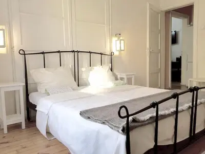 a bedroom with a large bed with white sheets and pillows at Interhost Guest rooms and apartments in Sofia