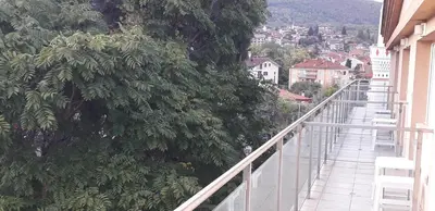 a balcony of a building with a view of a city at Heat Complex Family Hotel in Peshtera