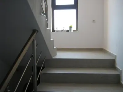 a staircase with a window in a white room at Khan Krum House & Apartments for rent in Elin Pelin