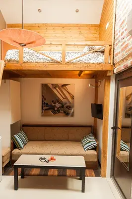 a living room with a couch and a bunk bed at Vitosha Blvd - Attic Studio in Sofia