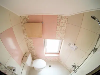 a bathroom with a toilet and a window at Vitosha Blvd - Attic Studio in Sofia