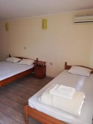 two twin beds in a room with at Комплекс Рожена, хотел, хотелски комплекс Рожена in Rozhen