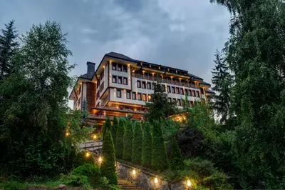 a large building with lights in front of it at Shiroka Laka Hotel in Shiroka Lŭka