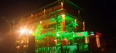 a building with green lights on the side of it at Комплекс 