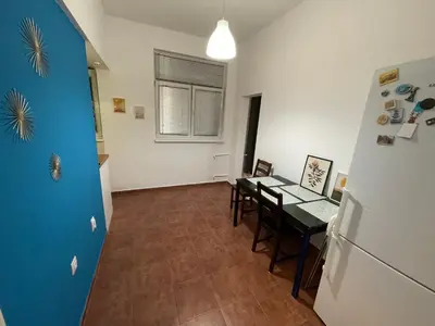 a kitchen and dining room with a refrigerator and a table at Top center 