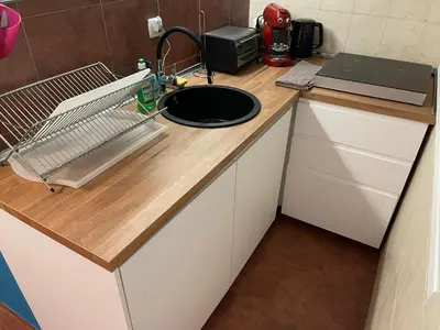 a kitchen counter with a sink and a microwave at Top center 