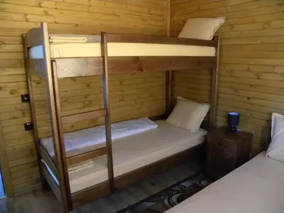 a bunk bed in a cabin with two bunk beds at Ваканционно селище Ива in Sarnitsa