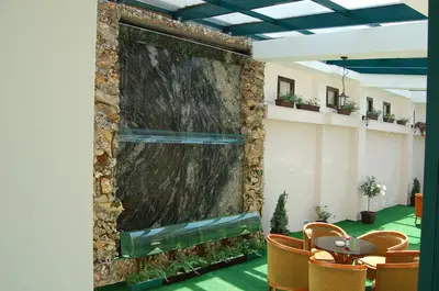 a large screen in a room with a table and chairs at Kniaz Boris Hotel in Sofia