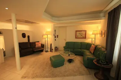 a living room with a green couch and a table at Cozy Flat in Sofia