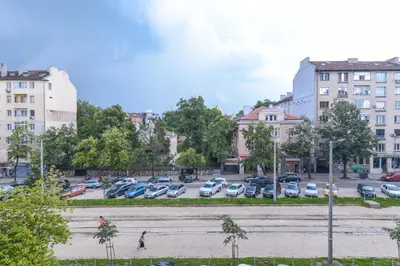a parking lot in a city with cars parked at Visit Sofia Macedonia Square Central Apartment by Flat Mаnager in Sofia