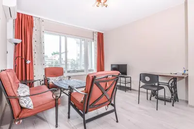 a living room with chairs and a table and a window at Visit Sofia Macedonia Square Central Apartment by Flat Mаnager in Sofia