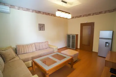 a living room with a couch and a table at Apartment Geo Milev in Plovdiv
