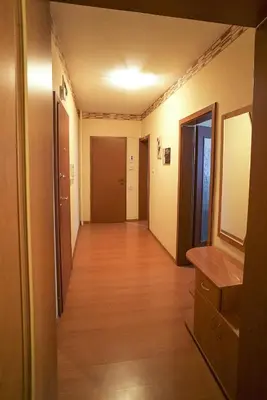 a hallway of an apartment with wooden floors and doors at Apartment Geo Milev in Plovdiv