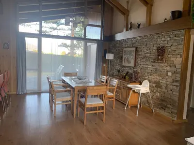 a dining room with a wooden table and chairs at Pirin Golf Villa Emila in Bansko