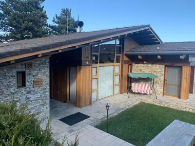 a house with a porch with a gazebo at Pirin Golf Villa Emila in Bansko