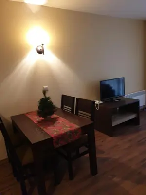 a living room with a table and a television at Dream Apart Hotel 207 in Bansko