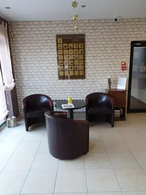 a restaurant with chairs and tables and a brick wall at Dream Apart Hotel 207 in Bansko
