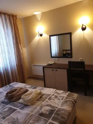 a bedroom with a bed with a dresser and a mirror at Dream Apart Hotel 207 in Bansko