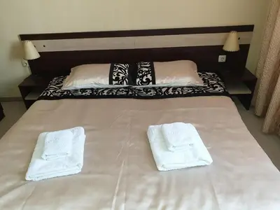 a bed with two white towels on top of it at Dream Apart Hotel 207 in Bansko