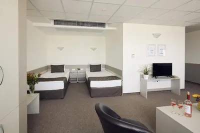 a hotel room with two beds and a tv at Park Hotel Moskva in Sofia