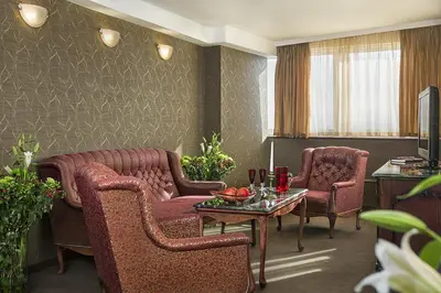 a living room with two chairs and a table at Park Hotel Moskva in Sofia
