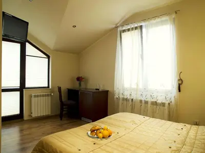 a bedroom with a bed with a bowl of fruit on it at Bizev Hotel in Bansko