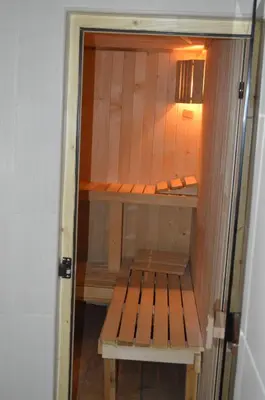 a room with a wooden bench in a room at Hotel Gazei in Bansko