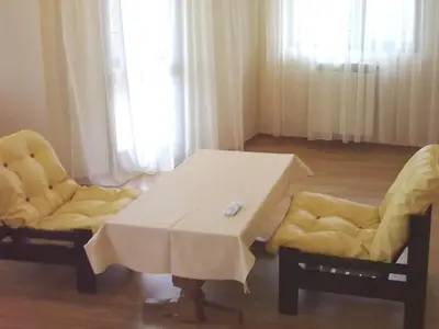 a white table and two chairs in a room at Hotel Gazei in Bansko