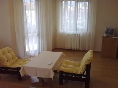 a living room with a table and two chairs at Hotel Gazei in Bansko