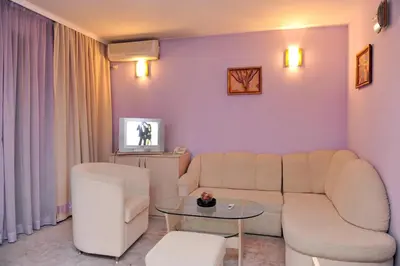 a living room with a couch and a table at Семеен Хотел Сокол in Sandanski